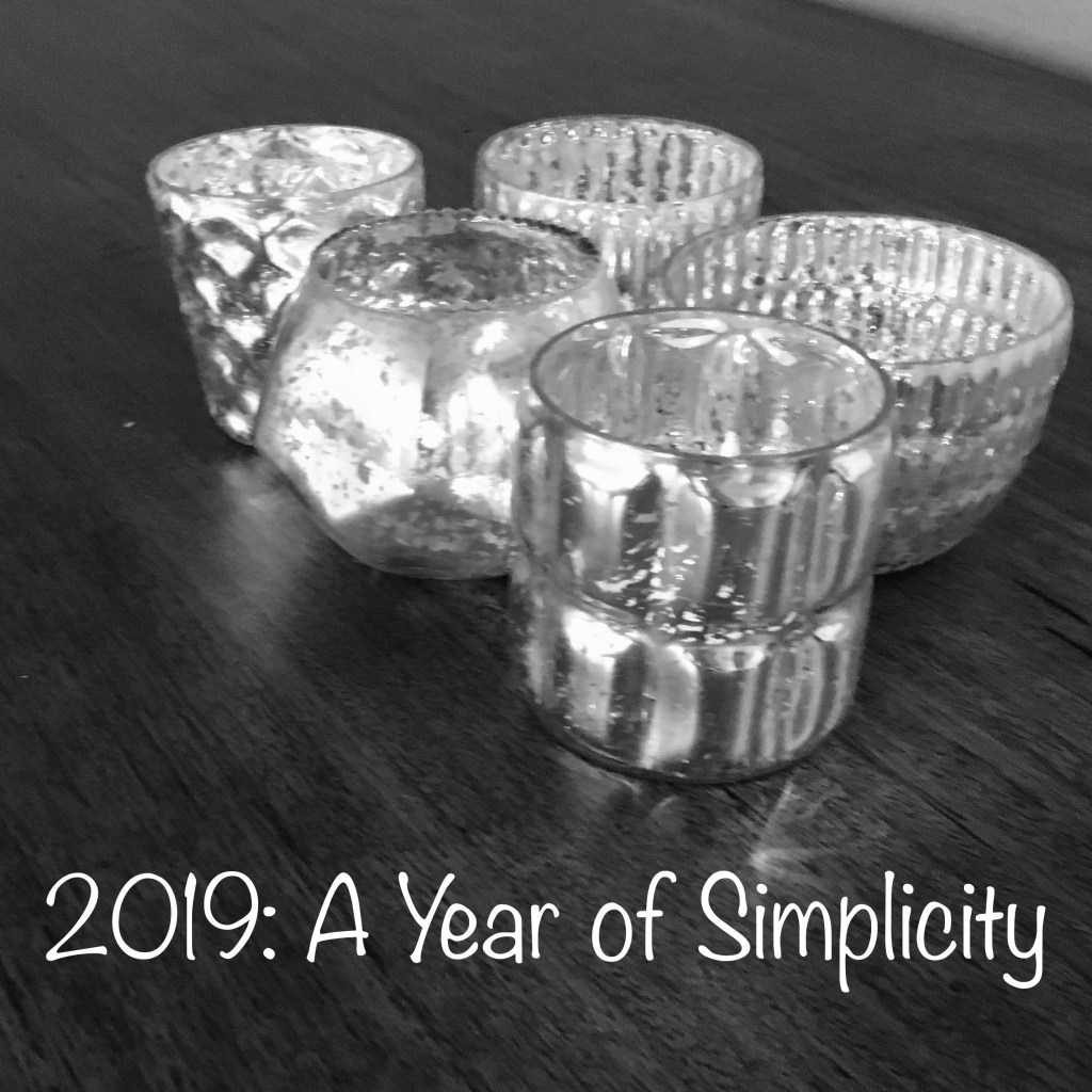 five candle holders sitting on a table with the text "2019: A Year of Simplicity"