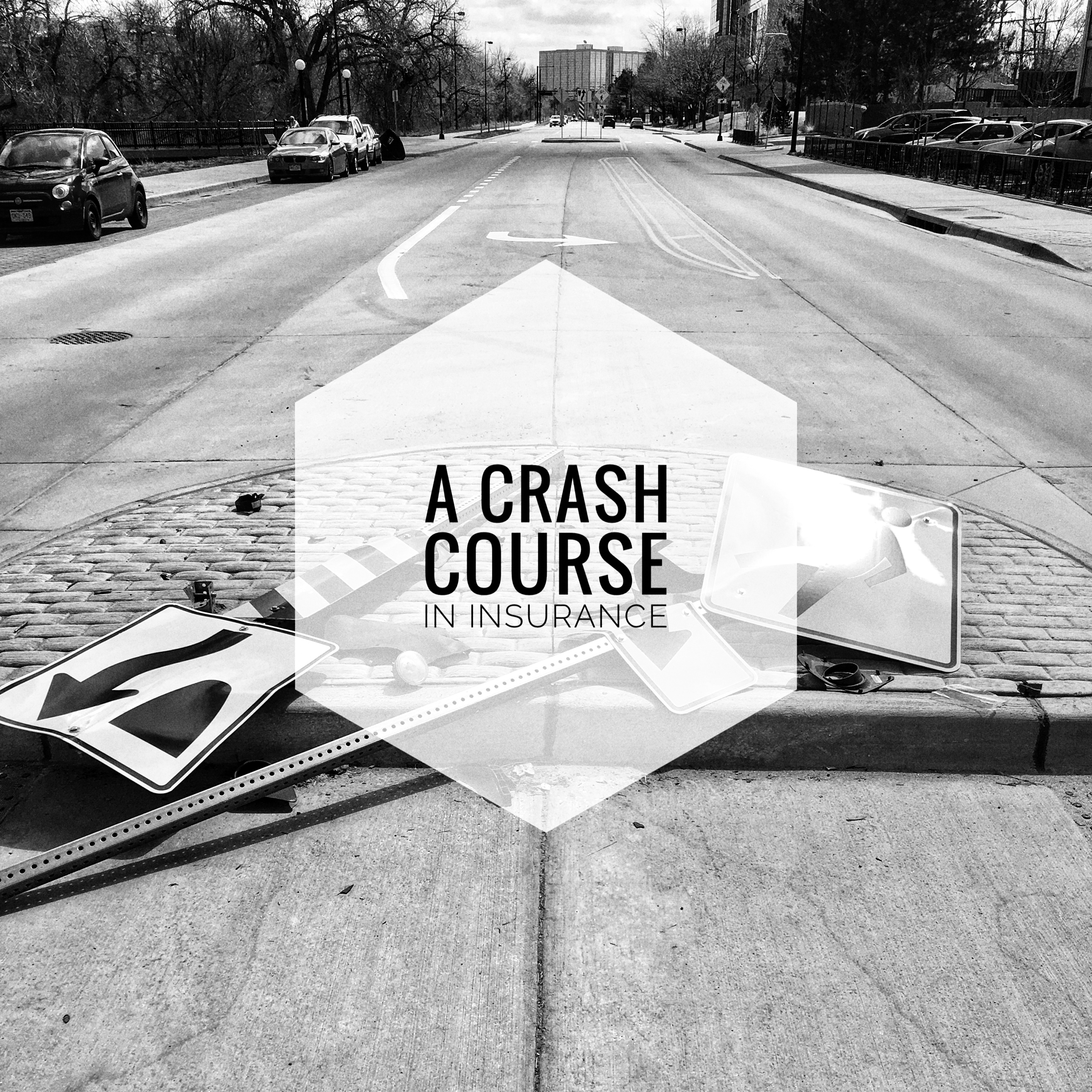 A street with two knocked over street signs and the words "a crash course in insurance" overlaid