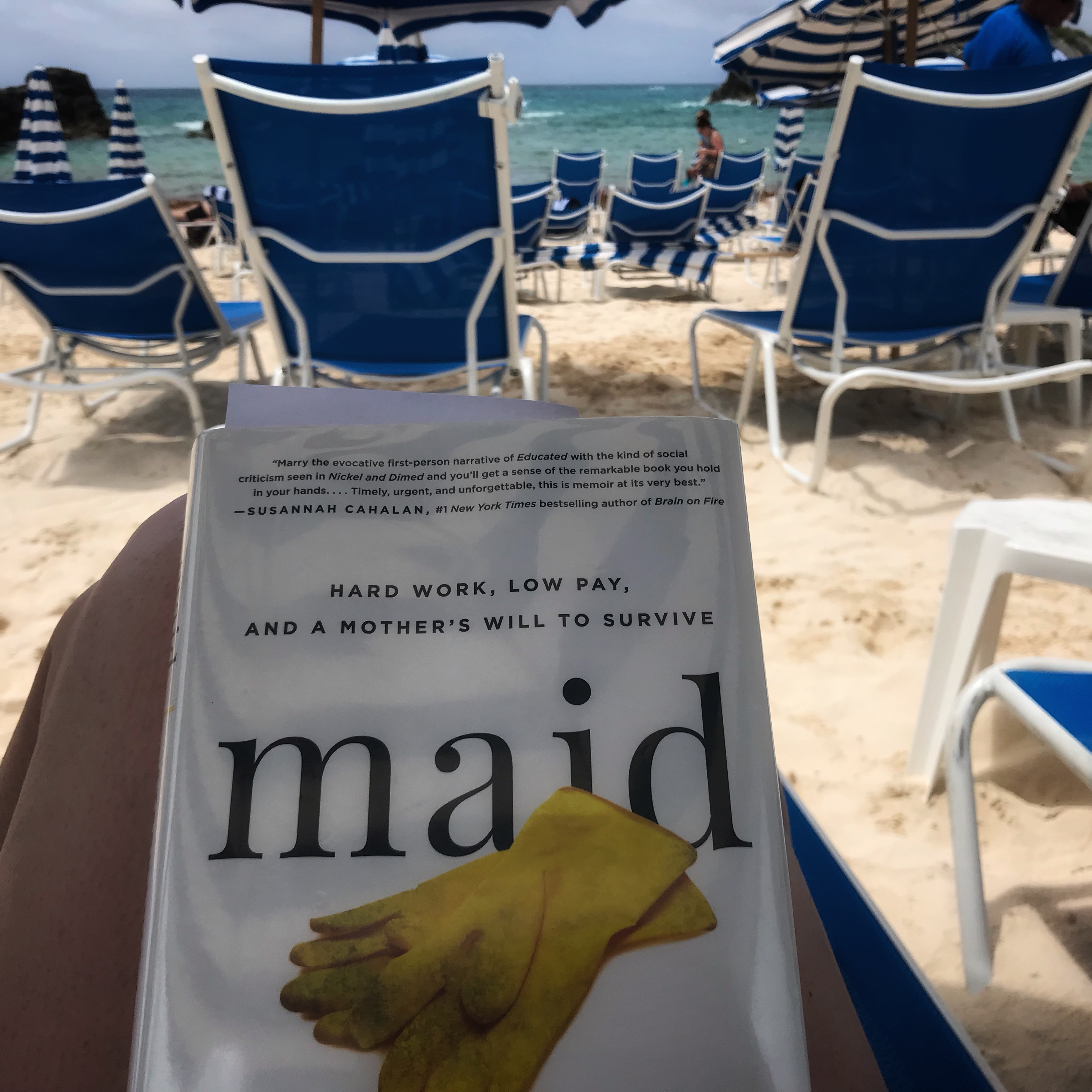 The book in my lap with the ocean in the background